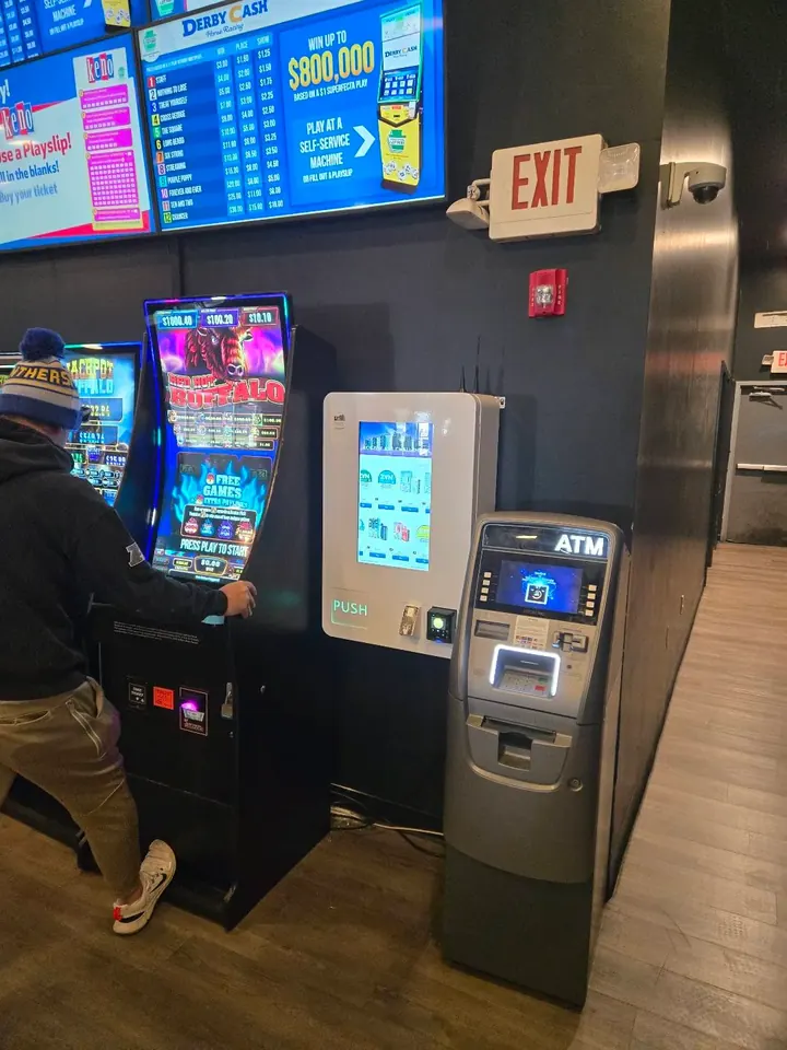 Wall-mounted nicotine pouch machine next to an ATM